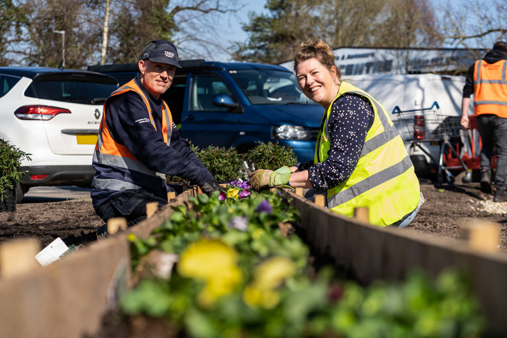 Tesco Thornbuy Volunteers planting a raised flower bed